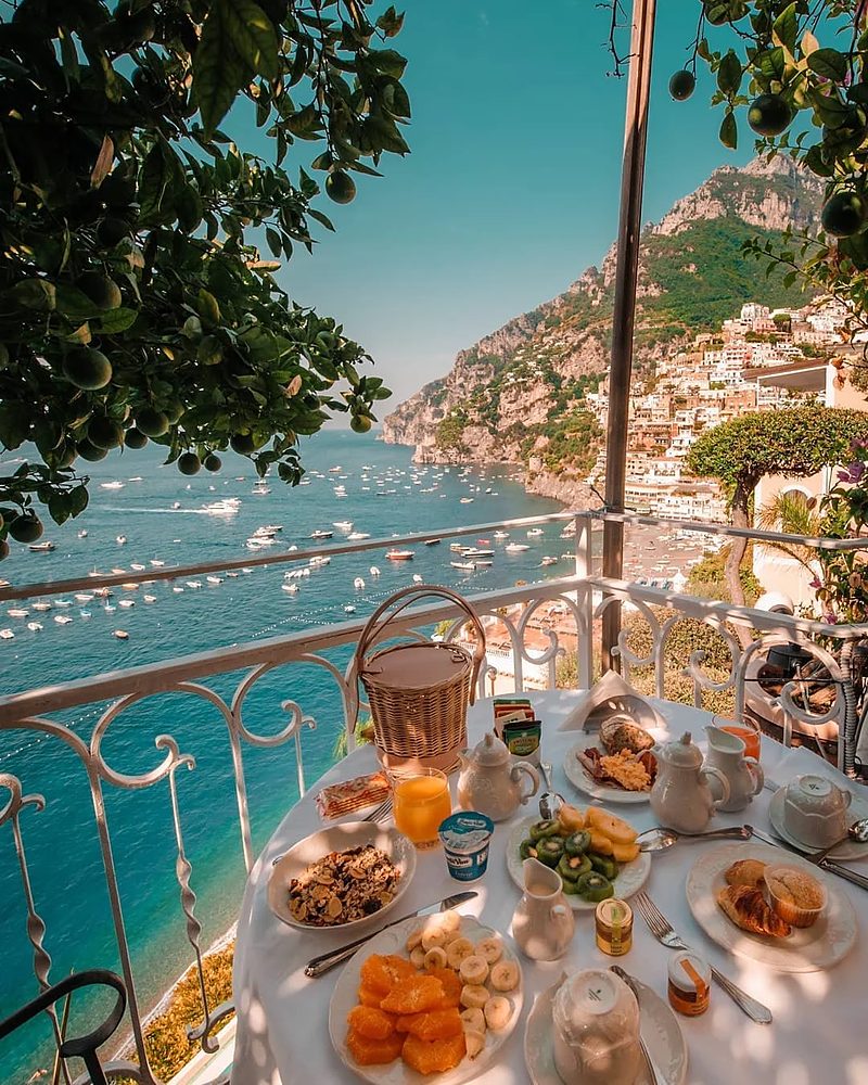 Café da manhã em terraço de hotel boutique com vista para Positano e a Costa Amalfitana